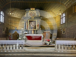 Koszecin, Poland, January 4, 2024: Interior of the old wooden church of the Holy Trinity in Koszecin, Poland. Main altar with