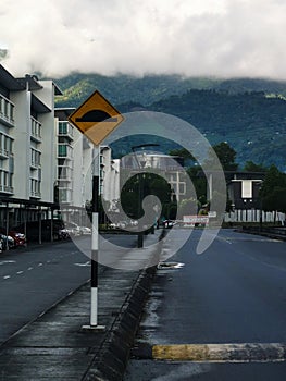 Speed bump sign beside asphalt road.