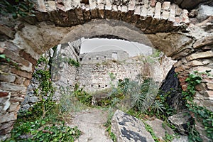 Kotor Fortress framed by an ancient stone archway,Montenegro