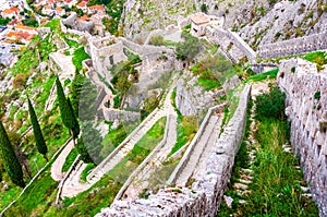 Kotor fortress walls, Montenegro with old steps and green trees