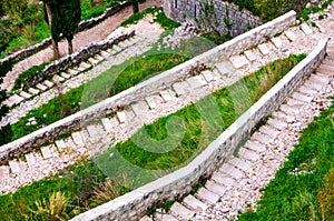 Kotor fortress walls, Montenegro with old steps and green trees