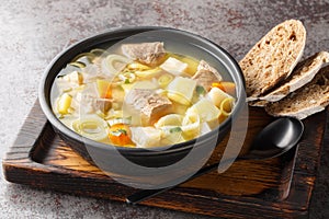 Kottsoppa soup is a meat and root vegetables include carrot, potato, celeriac, parsnip, turnip and Rutabaga close-up on a plate.