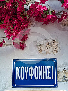 Koufonisia Sign on Whitewashed Wall With Red Bougainvillea, Greece