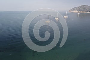 Koukounaries beach at Skiathos and four sailboats