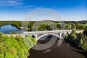 Kouvola, Finland - 4 June 2021: Summer aerial view of bridge with train and Kymijoki river waters