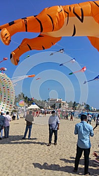 People flying kites and enjoying in Kite Festival in Trivandrum, India.
