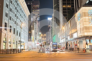 Night long exposure of passing vehicles on busy city street.