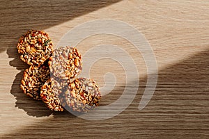 Kozinak cookies made from seeds and nuts on a wooden background. Flat lay, top view, copy space