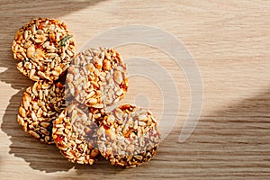Kozinak cookies made from seeds and nuts on a wooden background. Flat lay, top view, copy space
