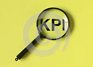 KPI acronym, word through magnifier. Key performance indicator research