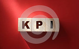 KPI on wooden blocks, key performance indicator KPI concept, top view on red