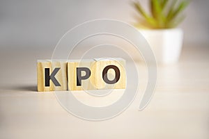 KPO - Knowledge Process Outsourcing, acronym business concept on wooden cubes