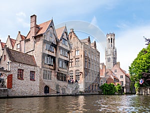 Kraanrei canal with historic buildings and belfry tower in Bruges, Belgium
