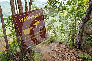 Krabi, Thailand: a placard `Warning! Beware of Dangerous Cliffs`