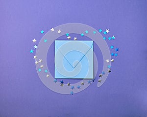 Kraft blue envelope  surrounded by confetti stars in the shape of a heart  on a paper lilac  color background. Mother`s Day,