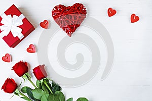 Kraft Gift box with beautiful white ribbon and red rose, candles in the form of a heart next to a red Kraft heart, on a white