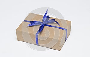 Kraft gift box with blue ribbon is on a white background