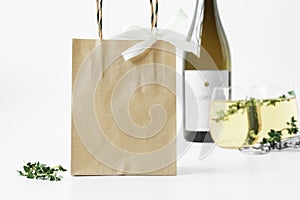 Kraft paper bag mockup with wine bottle and wine glass. photo