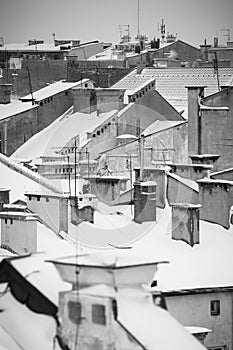 Krakow in Christmas time, aerial view on snowy roofs in central part of city. BW photo. Poland. Europe