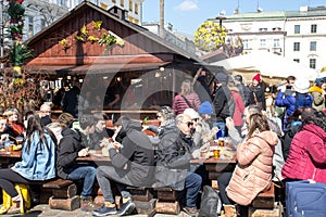 KRAKOW, POLAND, April 2, 2018, Many people sit at large wooden t