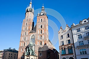 Old city center view with Adam Mickiewicz monument and St. Mary`s Basilica in Krakow