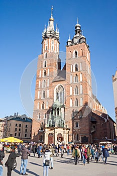 Old city center view with Adam Mickiewicz monument and St. Mary`s Basilica in Krakow