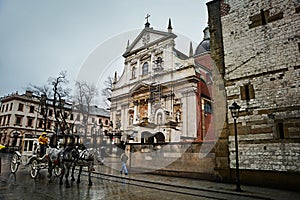 Krakow, Poland - February 23, 2016: Street of old Krakow in rainy evening, Krakow, Poland.