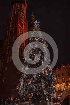 Krakow, Poland, Main Market square and Cloth Hall in the winter, during Christmas fairs decorated with Christmas tree.