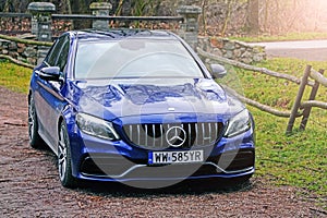 Krakow, Poland 19.02.2020: New luxury sport car Mercedes-benz C-class C63 AMG W205 blue color, parking in city park