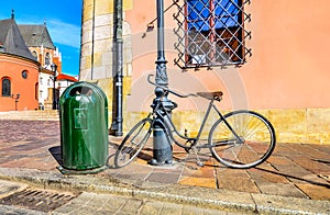 Krakow, Poland - retro bicycle parked on the european street near the pillar