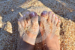 Kraksivy legs with a pedicure came to the sea, a pedicure on the beach, a summer pedicure, legs overlooking the sea and sand.,