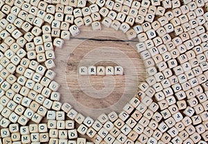 Krank, German text for Sick, word in letters on cube dices on table photo