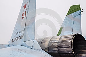 Krasnodar, Russia - February 23, 2017: The rear part of the Su-35 fighter. Steering flaps. A nozzle of a jet engine of an amber wi