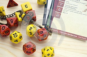 Playing Dungeons and Dragons, a role play game. Dices and cards lying on wooden surface. Deco photo