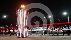 KRASNOYARSK, RUSSIA - MARCH 11, 2019: fire of universiade and the bridge in the dark