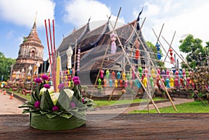 Krathong Festival on wood table with clipping path.At Wat Lokmolee background