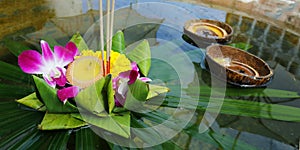 Krathong ,hand crafted floating basket by banana leaf,decorated with flowers and incense sticks, candle,
