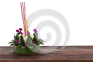 Krathong made of banana leaf and flowers for floating in the Lay Krathong Festival on wood table with clipping path