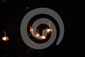 Krathongs floating on the river during Loi Krathong and Yi Peng