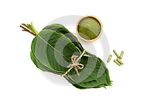 Kratom or Mitragyna speciosa green leaves, powder and capsule isolated on white background.top view,flat lay