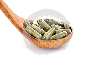 Kratom or Mitragyna speciosa powder in the capsules isolated on white background