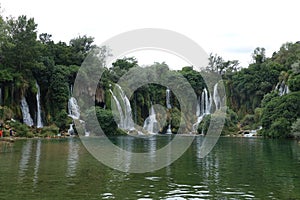 Kravica Waterfall is a large tufa cascade on the TrebiÅ¾at River, in the karstic heartland of Herzegovina in Bosnia