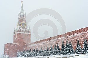 Kremlin chiming clock of the Spasskaya Tower in Moscow, Russia at wintertime during snowfall photo