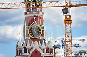 Kremlin clock up view with construction cranes photo