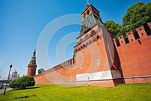 Kremlin red bricks wall view with green trees