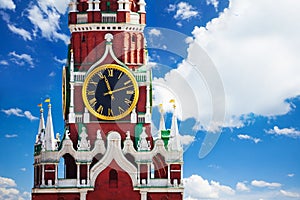 Kremlin Spasskaya tower clock over sky with clouds