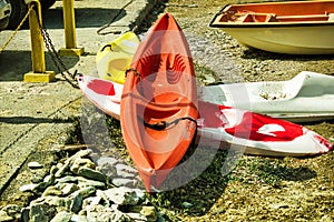 Kreta or Crete  Greece : Bunch of colorful kayaks kept on ground under the sun for tourist next to beach.