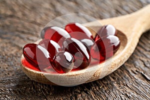 Krill oil pills on a spoon