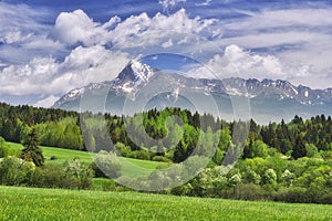 Krivan mountain in High Tatras mountains over meadows near Hybe village