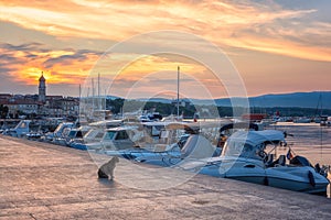 Krk, the largest town on the Krk island, Kvarner bay, Croatia. Scenic view of the harbor, embankment and Krk cathedral at sunrise